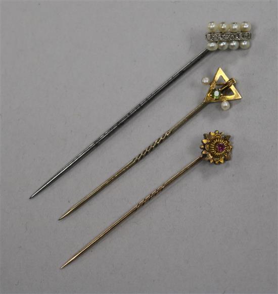 Three stick pins, including diamond and seed pearl and 9ct gold gem set.